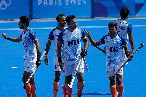 Harmanpreet Singh celebrates with teammates